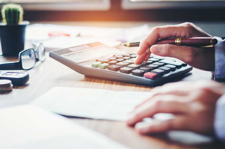 First-time homebuyer using a calculator to evaluate their finances