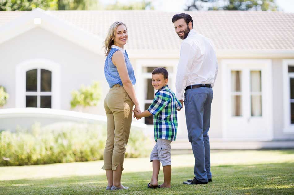 A family stands in front of a home trying to choose which type of home loan to get